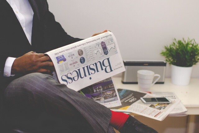 Business man reading the business news in a newspaper